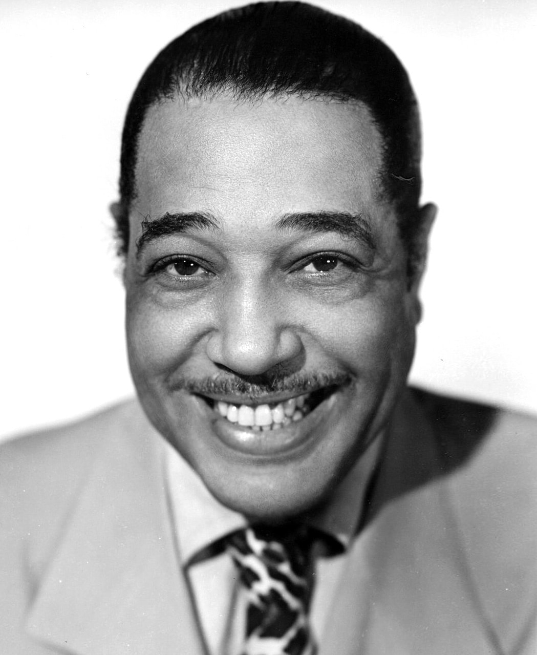 Black and white headshot of Duke Ellington smiling