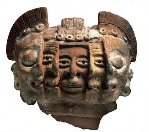Aztec clay sculpture with layers of faces