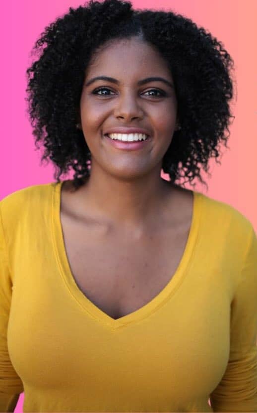 happy woman in yellow top smiling at camera 