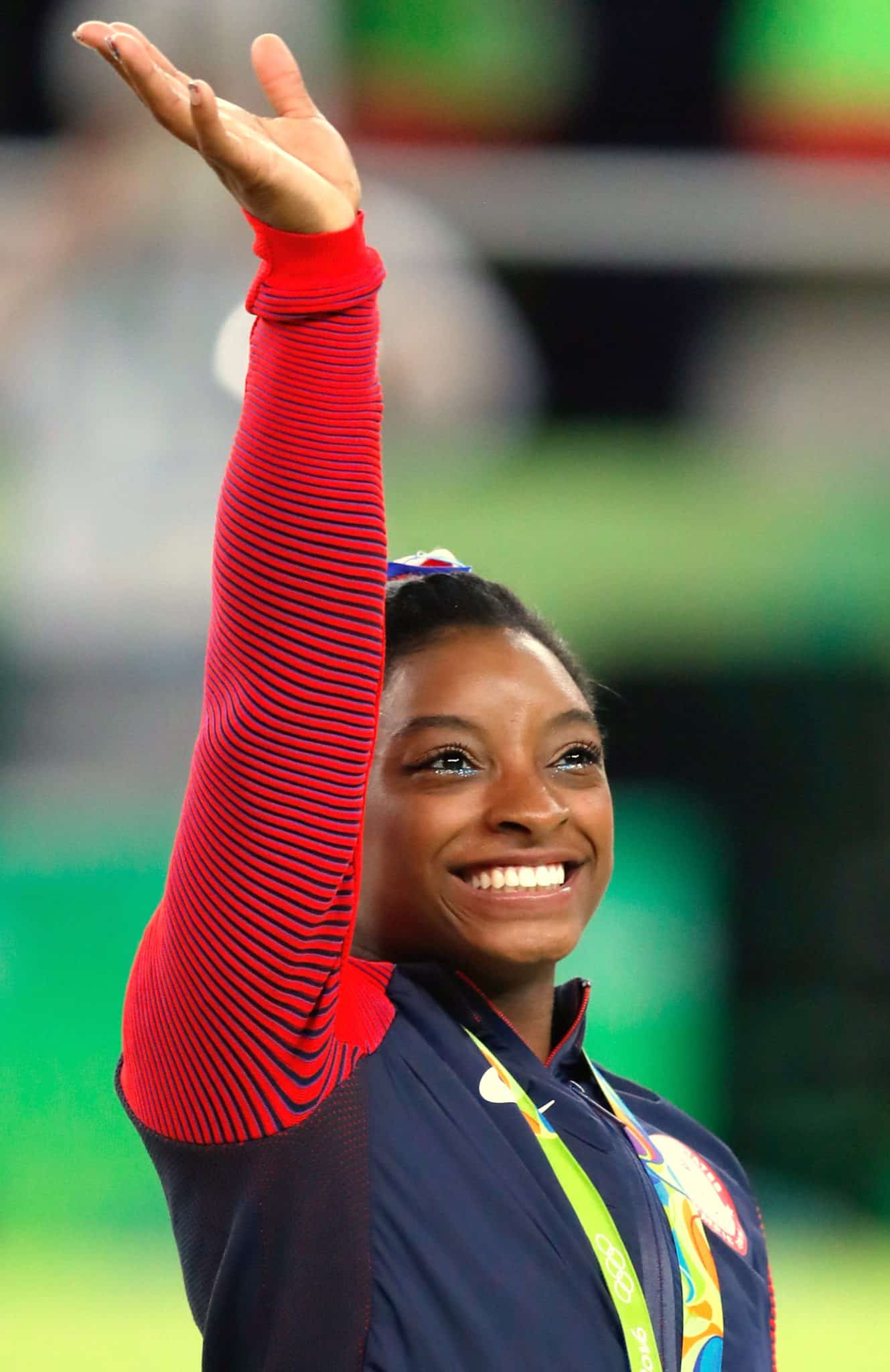 Happy Black woman waving at fans