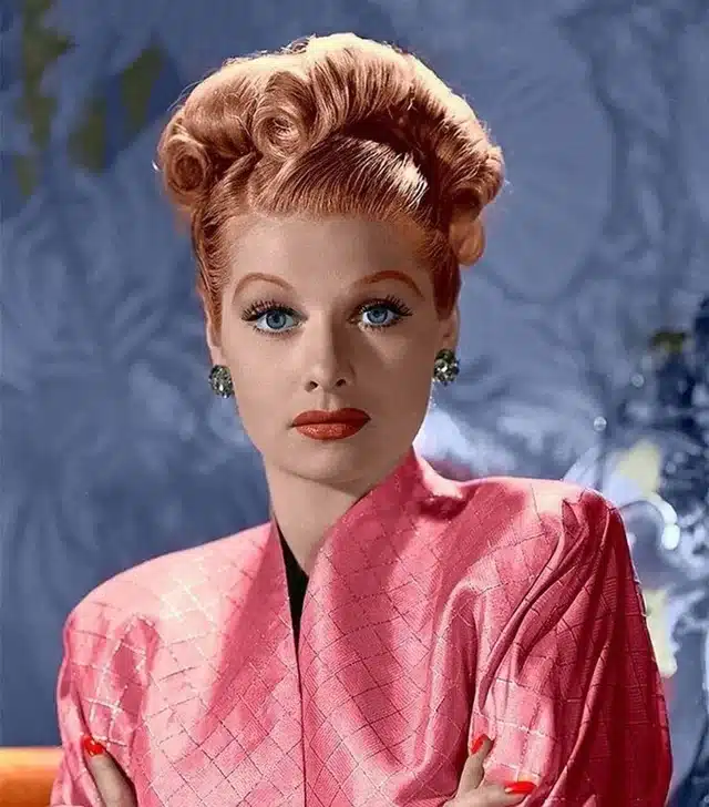 Glamor shot of Lucille Ball with red hair and pink dress