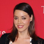 Headshot of Aubrey Plaza smiling at camera on red carpet