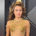 Miley Cyrus in gold dress at the 2024 Grammy Awards